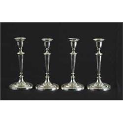 SET OF FOUR SILVER PLATED TALL CANDLESTICKS