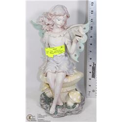 GARDEN FAIRY SITTING ON MUSHROOMS WITH A BUTTERFLY