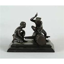 BRONZE FIGURAL GROUP OF TWO MEN SAWING LOG