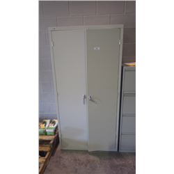 Upright metal shelving unit with doors