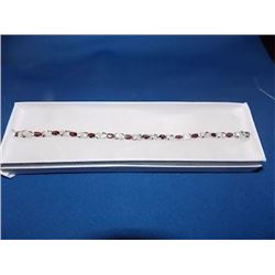BRACELET - 12 OVAL FACETED RICH DEEP RED/BROWN GARNETS IN STERLING SILVER CROSS OVER LINK DESIGN SET