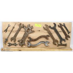 ANTIQUE TOOLS MOUNTED ON A DISPLAY