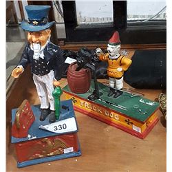 TWO CAST IRON COIN BANKS