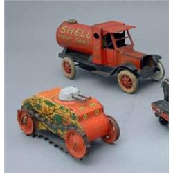 A tin-plate clockwork model of a petrol tanker, "Shell Motor Spirit" with red livery and stylised...