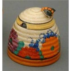 A Clarice Cliff 'Gayday' pattern honey pot and cover, painted in colours, H 3.5ins....