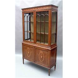 A Sheraton revival mahogany display cabinet having dentil cornice above two arched bar-glazed doo...