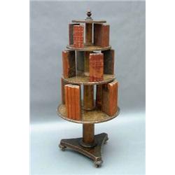 A Regency painted revolving bookcase, having three circular graduated tiers, each interspaced by...