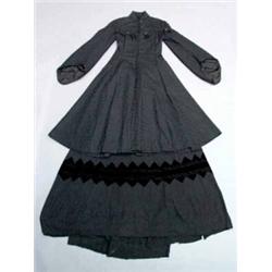 A two-piece Victorian style black silk damask theatrical costume, comprising a fitted coat trimme...