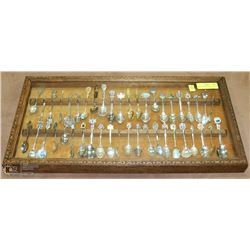 COLLECTION OF SPOONS IN DISPLAY CASE