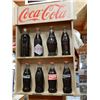 Image 1 : COCA- COLA  DISPLAY CABINET DISPLAYING BOTTLES FROM 1899- 1991 - 3 1/2" X 17  3/4" LOCATION: UPPER B