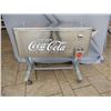 Image 1 : STAINLESS COKE COOLER ON CART - 2 DOORS OPENER- CAP CONTAINER - 40" X 24 1/2" X 35" LOCATION: SODA S