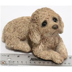 SANDSTONE PUPPY LAYING DOWN