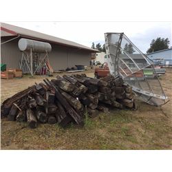 Pile of Misc salvage railway ties and large satellite dish