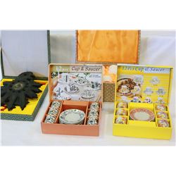 THREE BOXED TEA SETS AND BOXED EASTERN PLAQUE