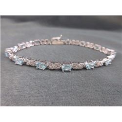 BRACELET - OVAL FACETED BLUE TOPAZ (13) & DIAMOND IN STERLING SILVER INFINITY LINK DESIGNED SETTING 