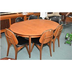 Mid century modern round teak dining table with two 20  insert leaves and six chairs with upholstere