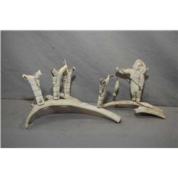 Two Inuit antler carvings including a four person spear hunting team 11  across and a mother and chi