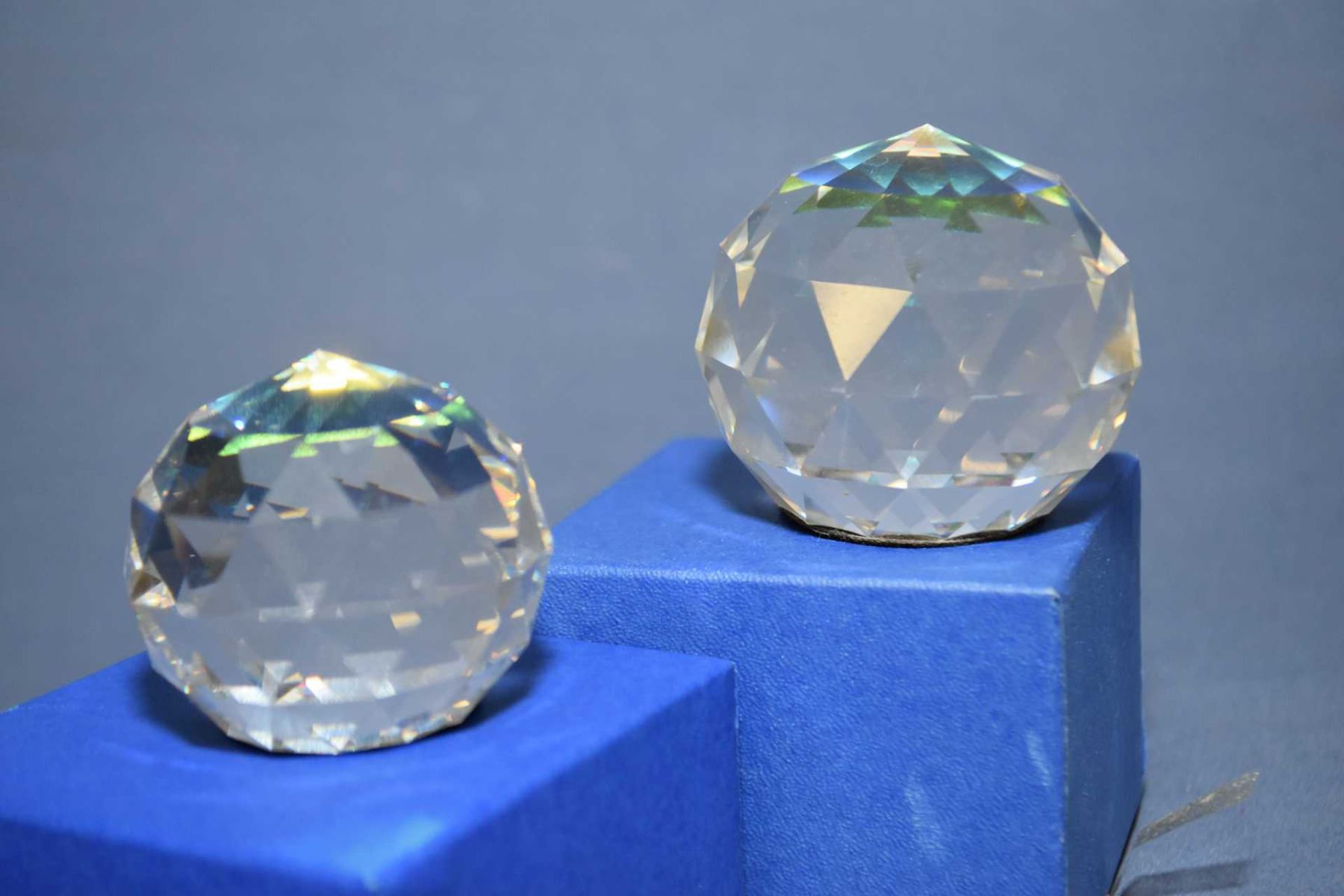 Two Swarovski crystal prisms, one 2 1/4" diameter and one 2" diameter