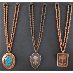THREE COPPER CHAINS AND PENDANTS MARKED BELL TRADING