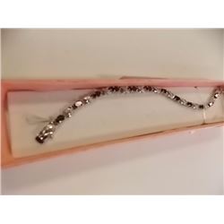 BRACELET - 6 CTW OVAL FACETED GARNET (12) & DIAMOND IN STERLING SILVER CROSS OVER DESIGNED SETTING -