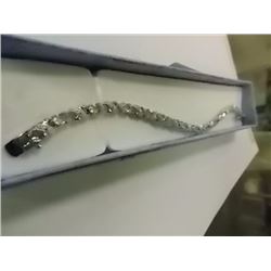 BRACELET - 6CTW OVAL FACETED BLUE TOPAZ (12) & DIAMOND IN STERLING SILVER CROSS OVER DESIGNED SETTIN