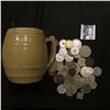 Image 1 : Stoneware Mug "Uhl Pottery Co. 16 Huntingburg Ind." with a large group of unsorted foreign coins and