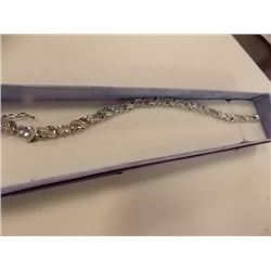 BRACELET - 6CTW OVAL FACETED BLUE TOPAZ (12) & DIAMOND IN STERLING SILVER CROSS OVER DESIGNED SETTIN