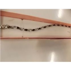 BRACELET - 6 CTW OVAL FACETED GARNET (12) & DIAMOND IN STERLING SILVER CROSS OVER DESIGNED SETTING -