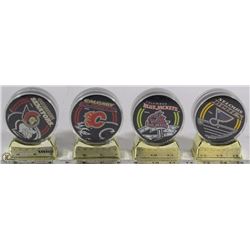 SET OF 4 NHL ENCASED HOCKEY PUCKS ON STAND