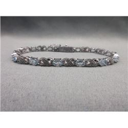 BRACELET - 6CTW OVAL FACETED BLUE TOPAZ (12) & DIAMOND IN STERLING SILVER CROSS OVER DESIGNED SETTIN