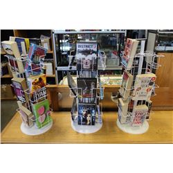 THREE DISPLAY STANDS WITH DVDS AND BOOKS