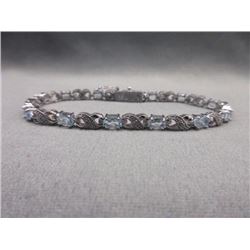 BRACELET - 6CTW OVAL FACETED BLUE TOPAZ (12) & DIAMOND IN STERLING SILVER CROSS OVER DESIGNED SETTIN