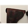 Image 9 : Two leather flap holsters for Luger  semi-automatic pistols, one black, one brown.        Est.:  $20