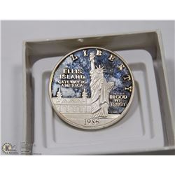 55) 1986 US LIBERTY ELLIS ISLAND SILVER DOLLAR