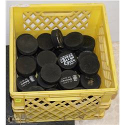 MILK CRATE PARTLY FULL OF HOCKEY PUCKS