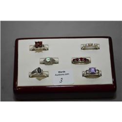 Six sterling silver rings all set with gemstones