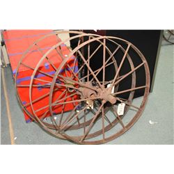 Three antique metal spoked impliment wheels