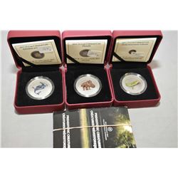 Three Royal Canadian mint glow in the dark 25 cent coins from the Pre-historic Creatures series incl