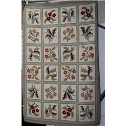 Quilt design hooked rug with floral panels and green and taupe border, 48" X 72"