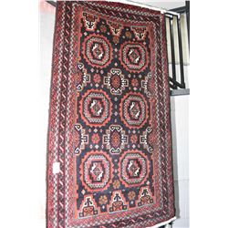 100% wool area rug with geometric design with multiple borders, in shades of royal blue, red and cre