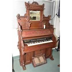 Antique Canadiana pump organ with fretwork and turned decoration, candle holders and bevelled mirror