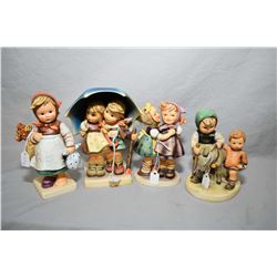 Four assorted Hummel and Goebel figures including "Stormy Weather", "Homeward Bound" etc.
