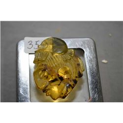 Carved Amber head with skull top regalia, 6.4 grams