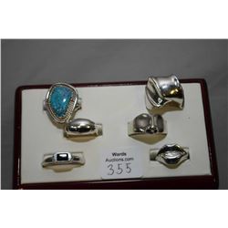 Six sterling silver artisan made rings including one set with turquiose