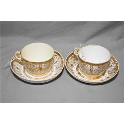 Pair of antique Minton bone china cups and saucers. Decorated with gilt borders, scrolls, stylized f