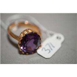 Ladies tested 20kt yellow gold ring set with one 11.76ct oval faceted synethic sapphire. Retail repl