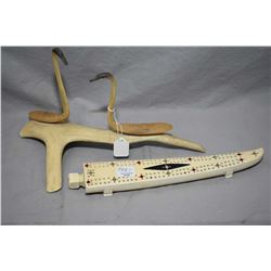 Inuit handcarved and handpainted bone cribbage board with cribbage pieces, 11 1/2" in length, and tw