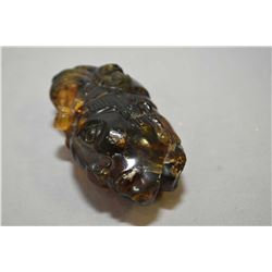 Carved Amber Aztec head with regaila 3" in height and weighing 61 grams