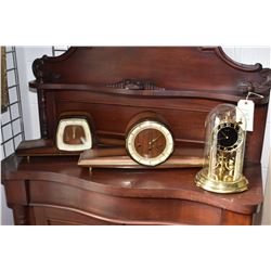 Three mantle clocks including two mid century walnut clocks and a Kundo glass domed anniversary cloc