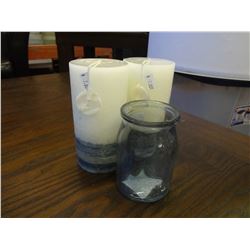 Light and navy blue candles, tinted blue glass